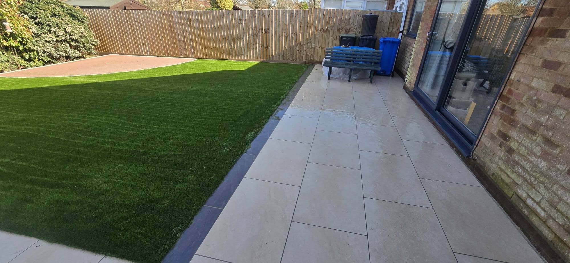 Porcelain path and new lawn in a fenced garden