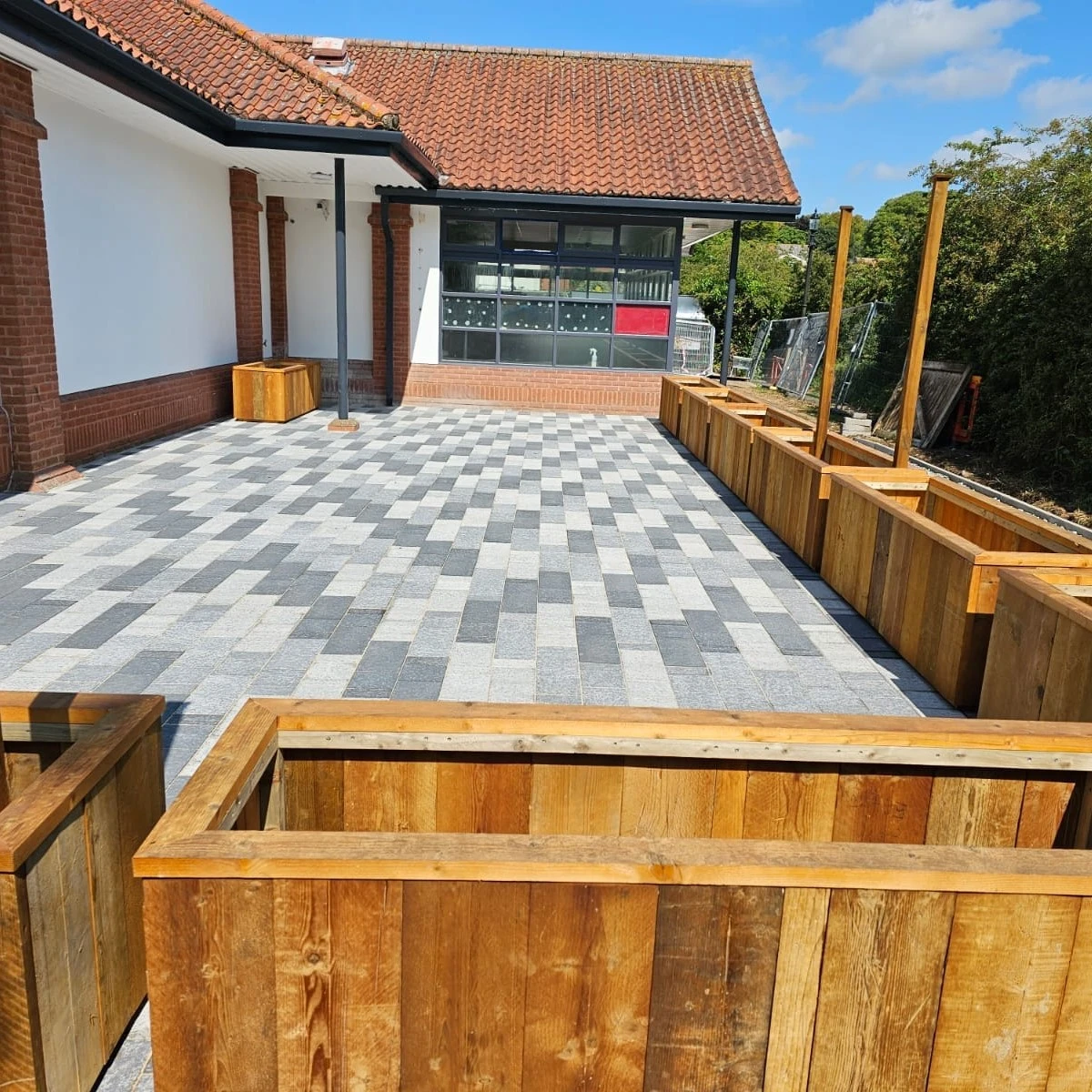 Grey block patio with timber planters