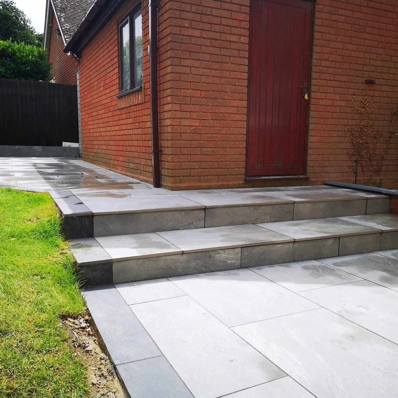 Porcelain patio with wide steps and lawn