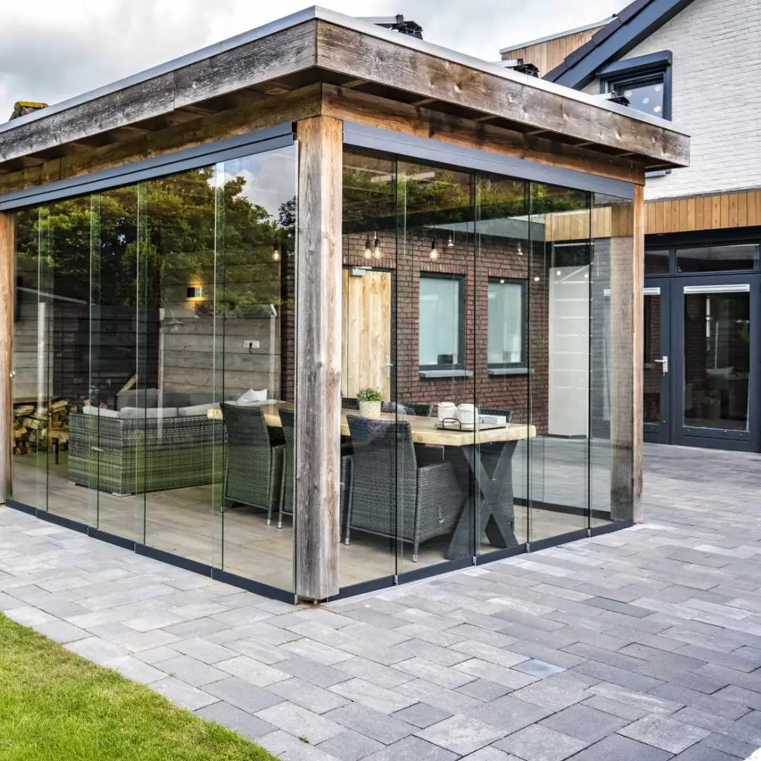 Glass garden room on a new patio in the evening
